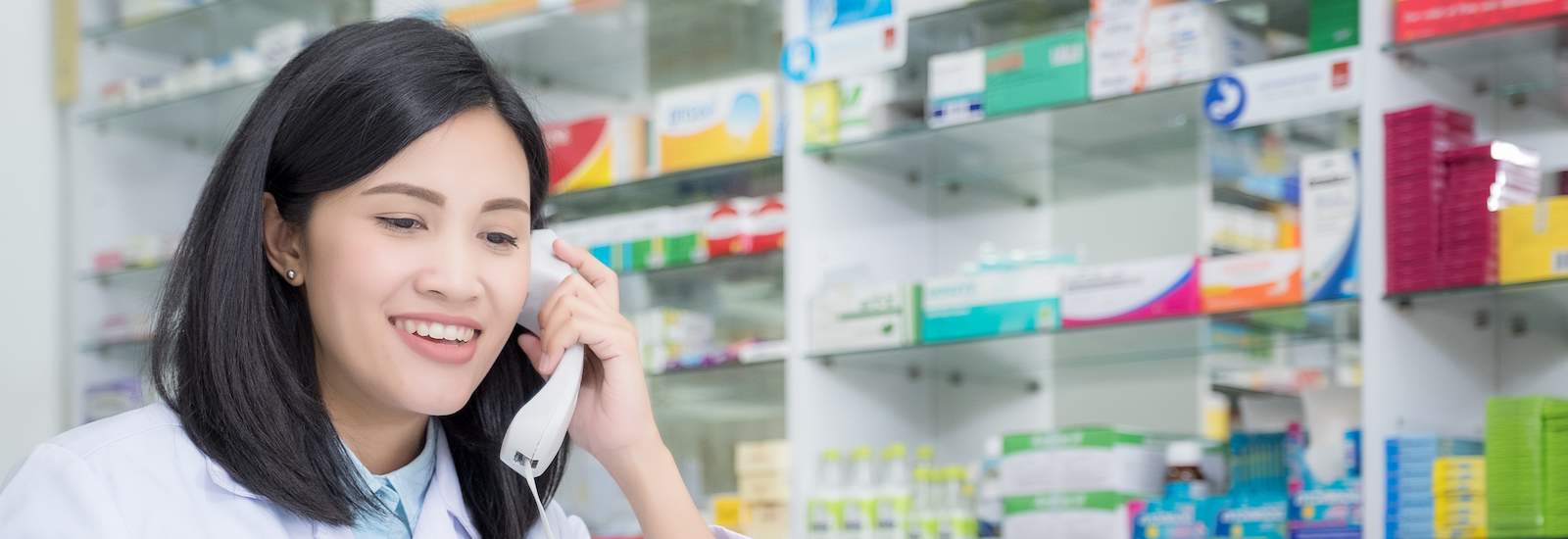 Pharmacy worker talking by phone