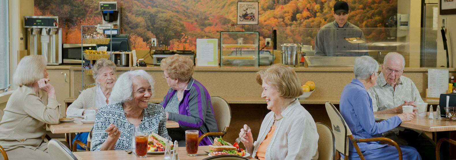 residents eating lunch and talking in bistro