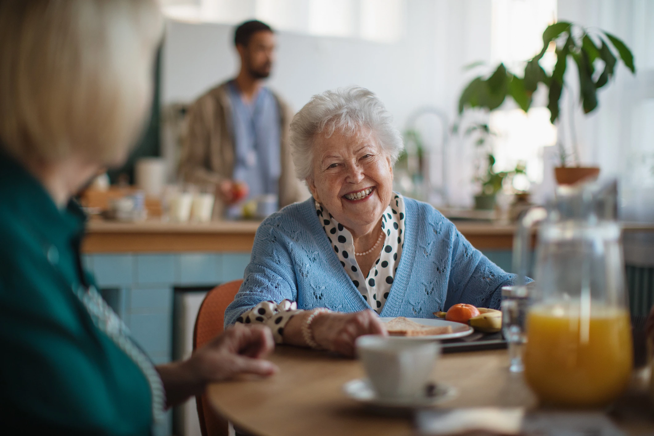 Older adult smiling in a senior living community during a social activity